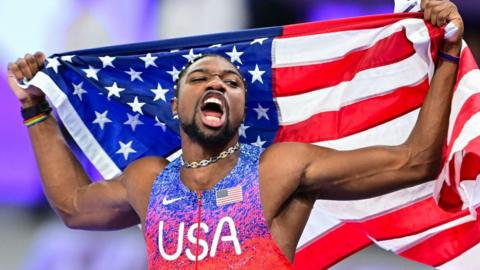 Noah Lyles celebrates Olympic men's 100m gold