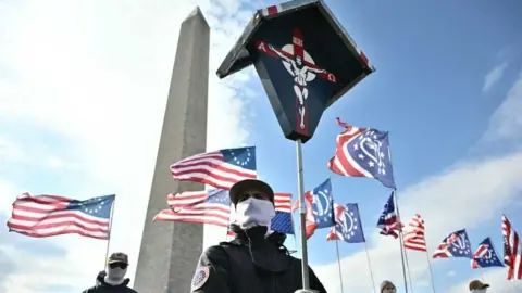 Anti-abortion activists hold flags in front of the Washington monument