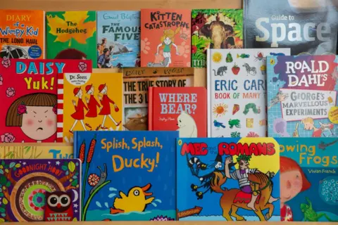 Getty Images Children's book selection on bookshelf including an Eric Carle collection and a Dr Seuss book