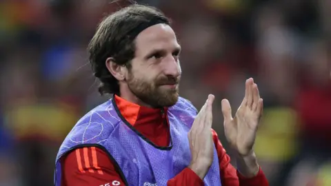 Joe Allen claps Wales fans earlier this season