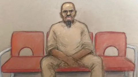 Julia Quenzler/BBC A sketch of Suleiman sitting on a chair in between two vacant red chairs. His legs are spread and his hands rest in between them, elbows on thighs. He looks straight ahead and looks serious 