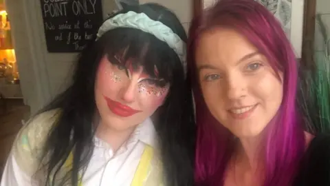 Clair Saxa Cerise Clair Saxa Cerise and one of her chosen family, they're both smiling at the camera