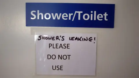 Sign at North Tees Hospital saying the shower/toilet is leaking