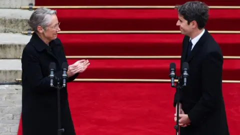 Reuters France's outgoing Prime Minister Elisabeth Borne applauds newly appointed Prime Minister Gabriel Attal during the handover ceremony at the Hotel Matignon in Paris, France, on January 9, 2024