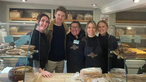 The Bakewell Pudding Shop Staff with actor Thomas Brodie-Sangster