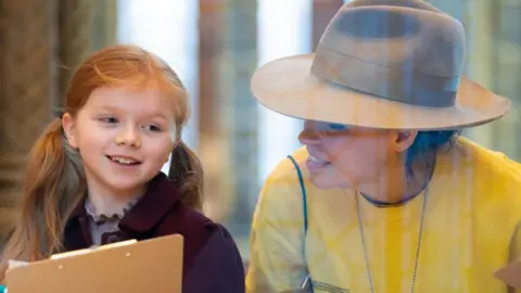 Artist Es Devlin helps a child with a still drawing at the Natural History Museum, in London, for the launch of The Wild Escape, a major new national campaign led by the Art Fund to respond creatively to the threat to the UK's natural environment