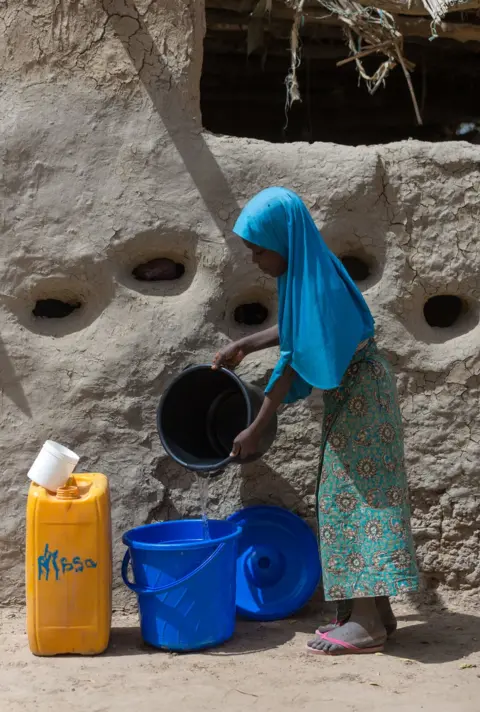 Aisha Augie-Kuta / WaterAid Malika pours water into a bucket in Norandé