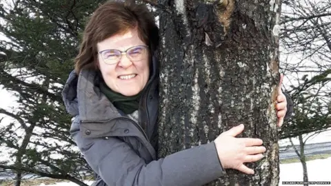 Iceland's Forest Service Woman hugging a tree