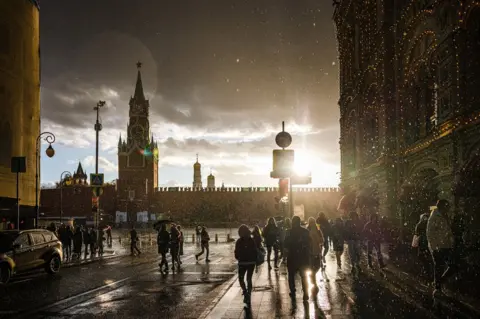 Dimitar Dilkoff / AFP People cross the Red Square in Moscow, Russia, on 23 October 2021