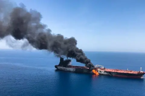 EPA The Norwegian-owned crude oil tanker Front Altair is seen on fire in the Gulf of Oman