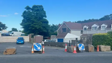 BBC Boulders have been put at the entrance of a hotel caught up in an asylum row