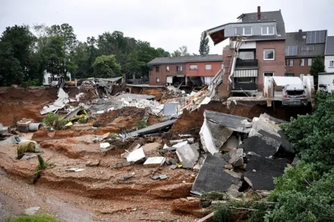 Sascha Steinbach / EPA Houses collapsed near a gravel pit in Erftstadt Blessem, Germany