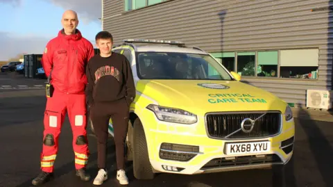 Great North Air Ambulance Service Corey Russell and GNAAS paramedic Ian Grey in front of rapid response vehicle. 