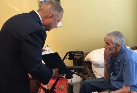 Kenny Dunn Lt Col LaFrazia presents a certificate of appreciation to Lawrence