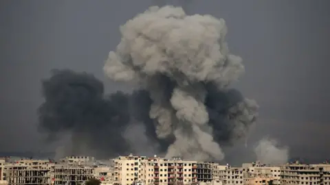 Getty Images A picture taken on 20 February 2018 shows smoke plumes over the besieged Eastern Ghouta region in Syria