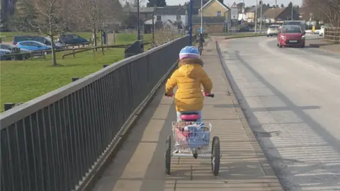 Nadine Hastings Isla riding her trike