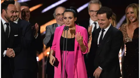 Getty Images Scarlett Moffatt accepting BAFTA with Ant and Dec