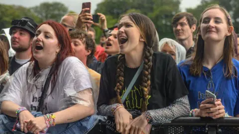 Getty Images Fans in rain at Leeds festival