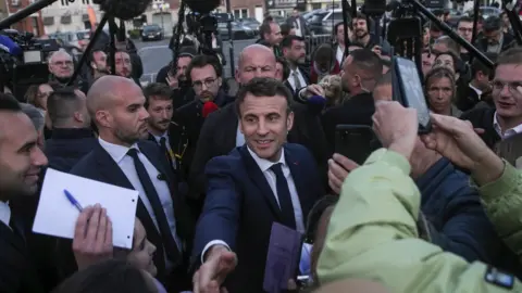 EPA Emmanuel Macron in a crowd of people and cameras