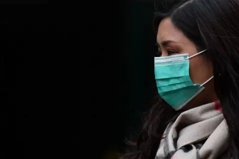 Getty Images Pedestrian wearing a face mask