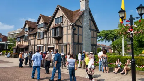 Getty Images A tourist group waiting in front of Shakespeare's Birthplace at Henley Street. Shakespeare's Birthplace