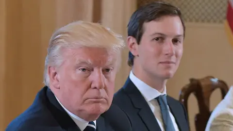 Getty Images Jared Kushner, right, is seen over the shoulder of President Donald Trump - both seated at a table during an official meeting