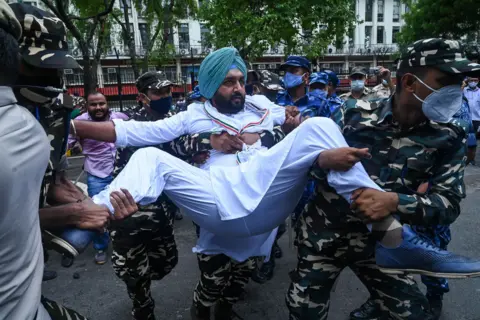 Prakash Singh / AFP In Delhi, members of India's Congress Party workers' wing are detained by security personnel during a demonstration against the government over alleged spyware surveillance, on 20 July 2021