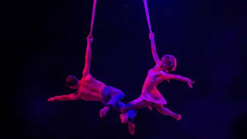 Marion Triverio Mykhaylo Pavlov and Nataliya Piontek performing as acrobats