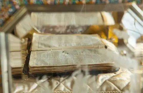 Antonio Olmos A Bible placed inside the casket of an organ clock