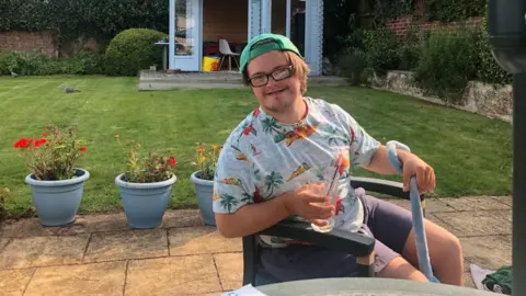 Family handout Charlie sat in garden