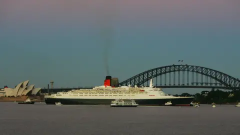 Ian Waldie The QE2 arrives in Sydney Harbour on its final voyage to Australia in 2008