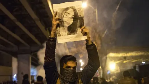 Getty Images Tehran protester holding up picture