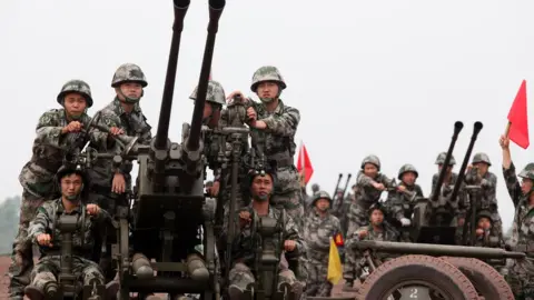 Getty Images Chinese troops practice with anti-aircraft guns during drills