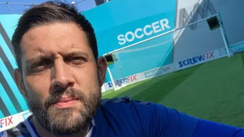 Hashtag Jacko Hashtag Jacko taking a selfie in front of the goal at Soccer AM's mini-arena