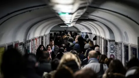 Getty Images Rail commuters in a tunnel