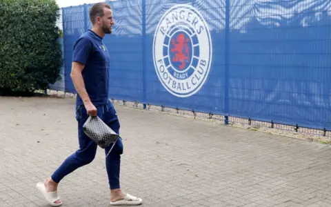 Getty Images Harry Kane at a training session, wearing his comfy slippers.