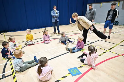 Jeff J Mitchell / Pool via REUTER Scotland's First Minister and leader of the Scottish National Party, Nicola Sturgeon, plays with children