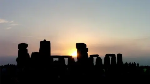 PA Media Sunrise over Stonehenge showing the silhouettes of the stones