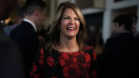 Getty Images Activist and Republican candidate Kelli Ward smiles at a conservative gathering near Washington, DC