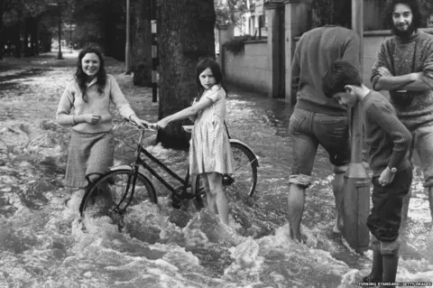 Evening Standard/Getty Images Flooding at the junction of Holland Park Gardens and Bayswater Road, London, after a water main burst