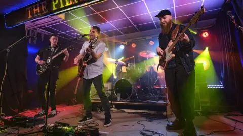 Chris Cook The Sam Evans band playing on stage