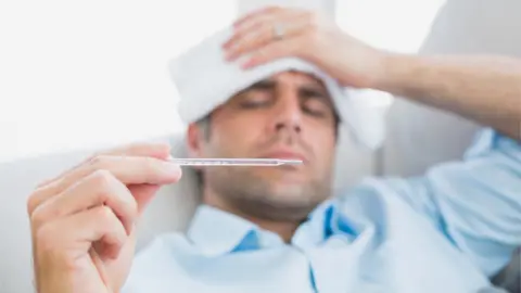 Getty Images/Thinkstock Man with a thermometer