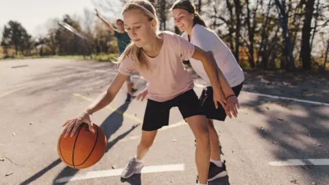 Getty Images teenagers playing basketball