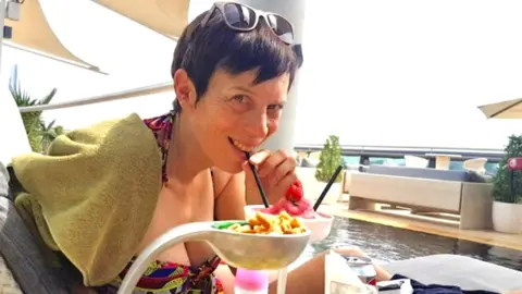 Family photo Michele Sephton drinking a cocktail and smiling at the camera