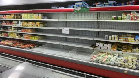 Reuters Empty shelves were seen where French products were displayed at Kuwaiti supermarkets