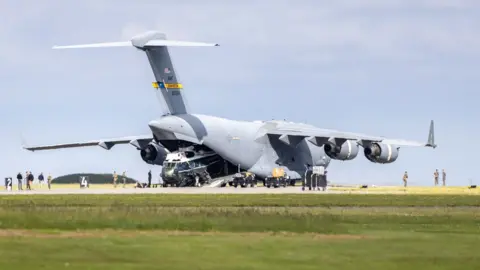 Kai Greet Sikorsky VH-3D helicopter in Globemaster cargo plane.