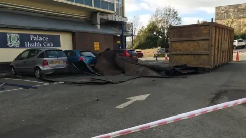 A section of felt roofing came off a hotel roof