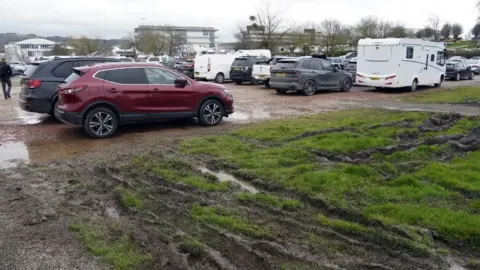 PA Media Cars at Cheltenham Festival and muddy ground