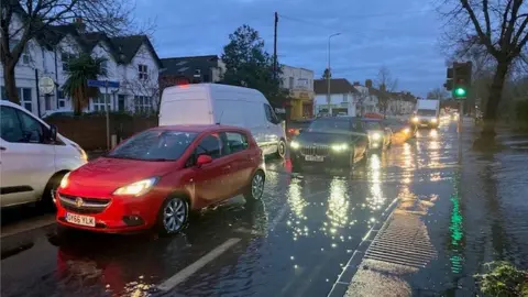 Cars driving through a flooded road