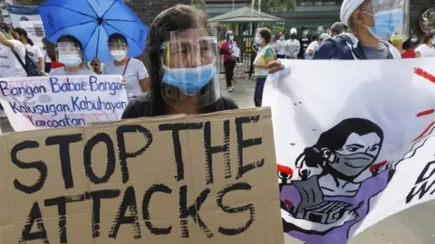 EPA A protester holds a sign during a rally marking International Women's Day in Quezon City, Metro Manila, Philippines, 8 March 2021